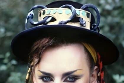 A woman wearing a hat and a black top hat