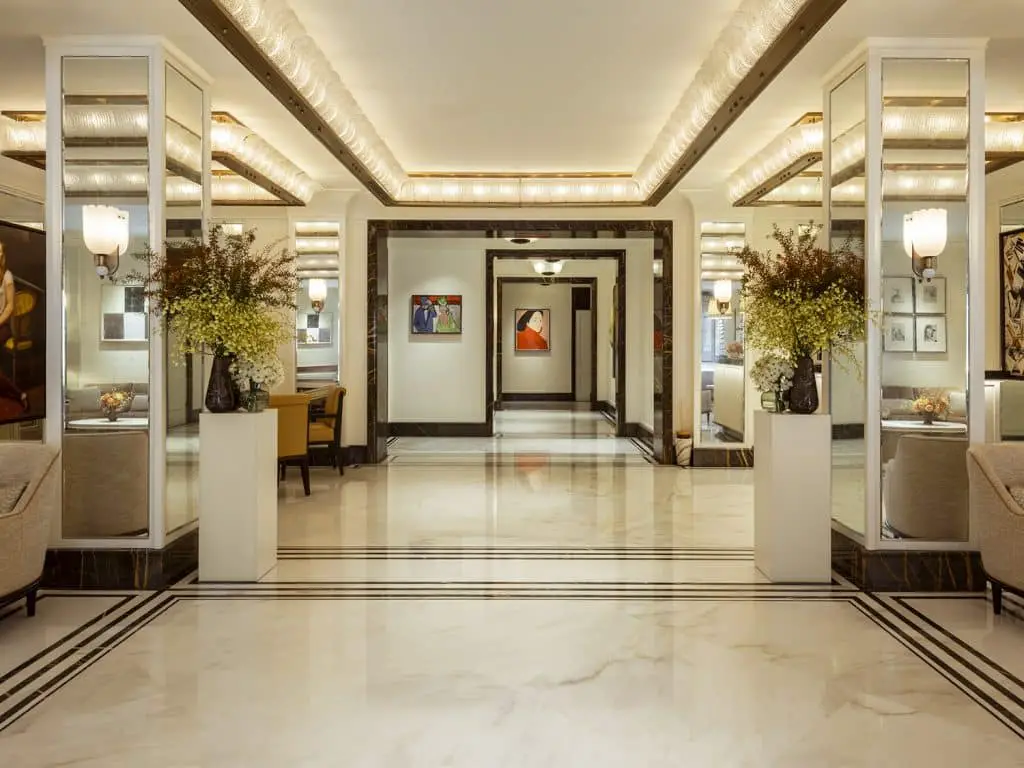 A hallway with mirrors and flowers